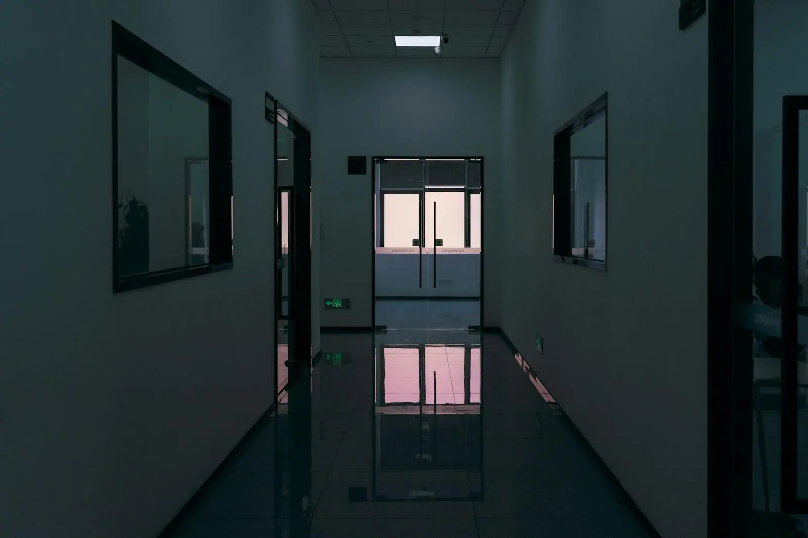 A quiet corridor ending in glass doors