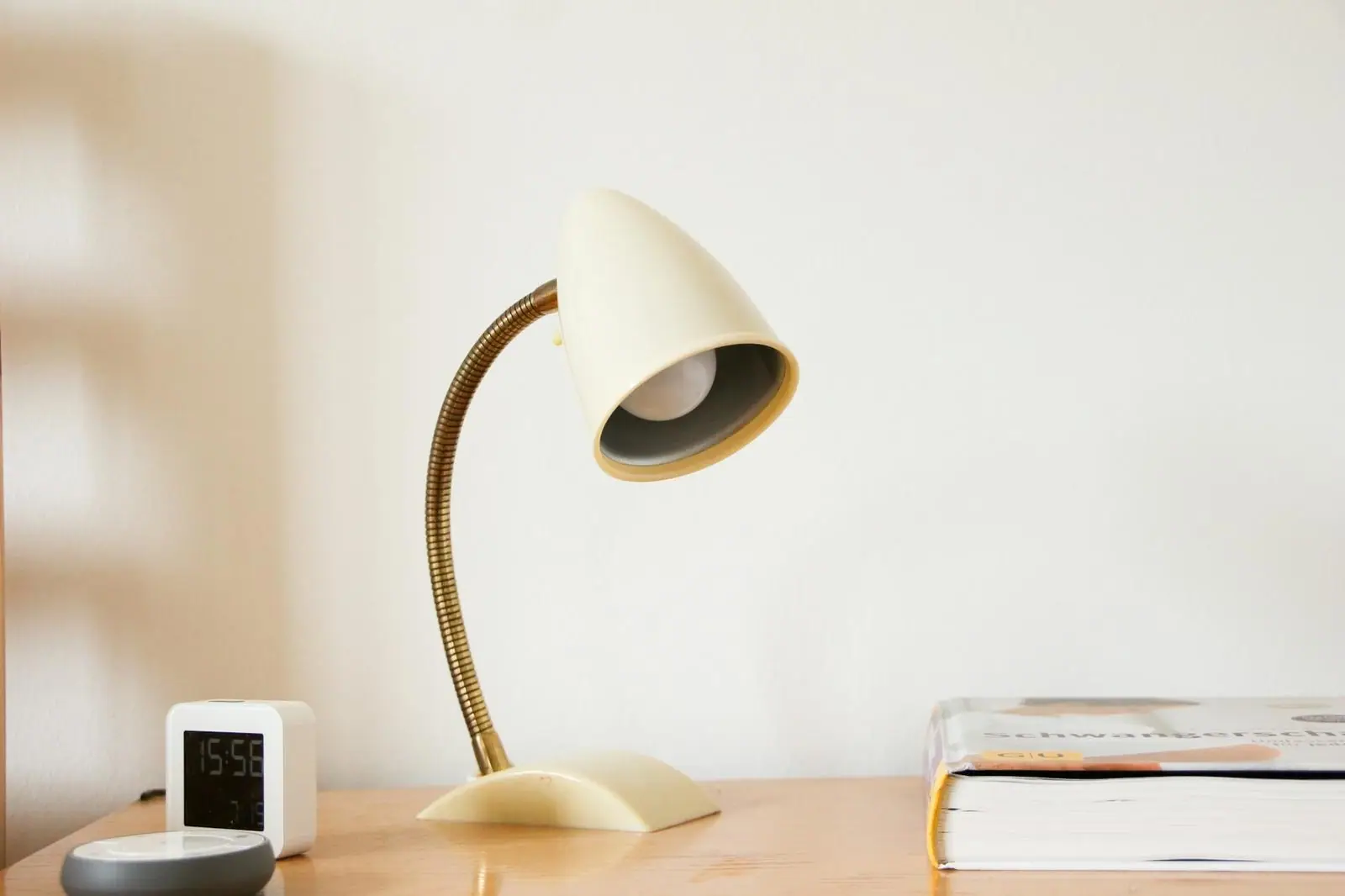 A table lamp beside an open book