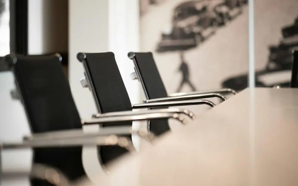A row of empty boardroom chairs